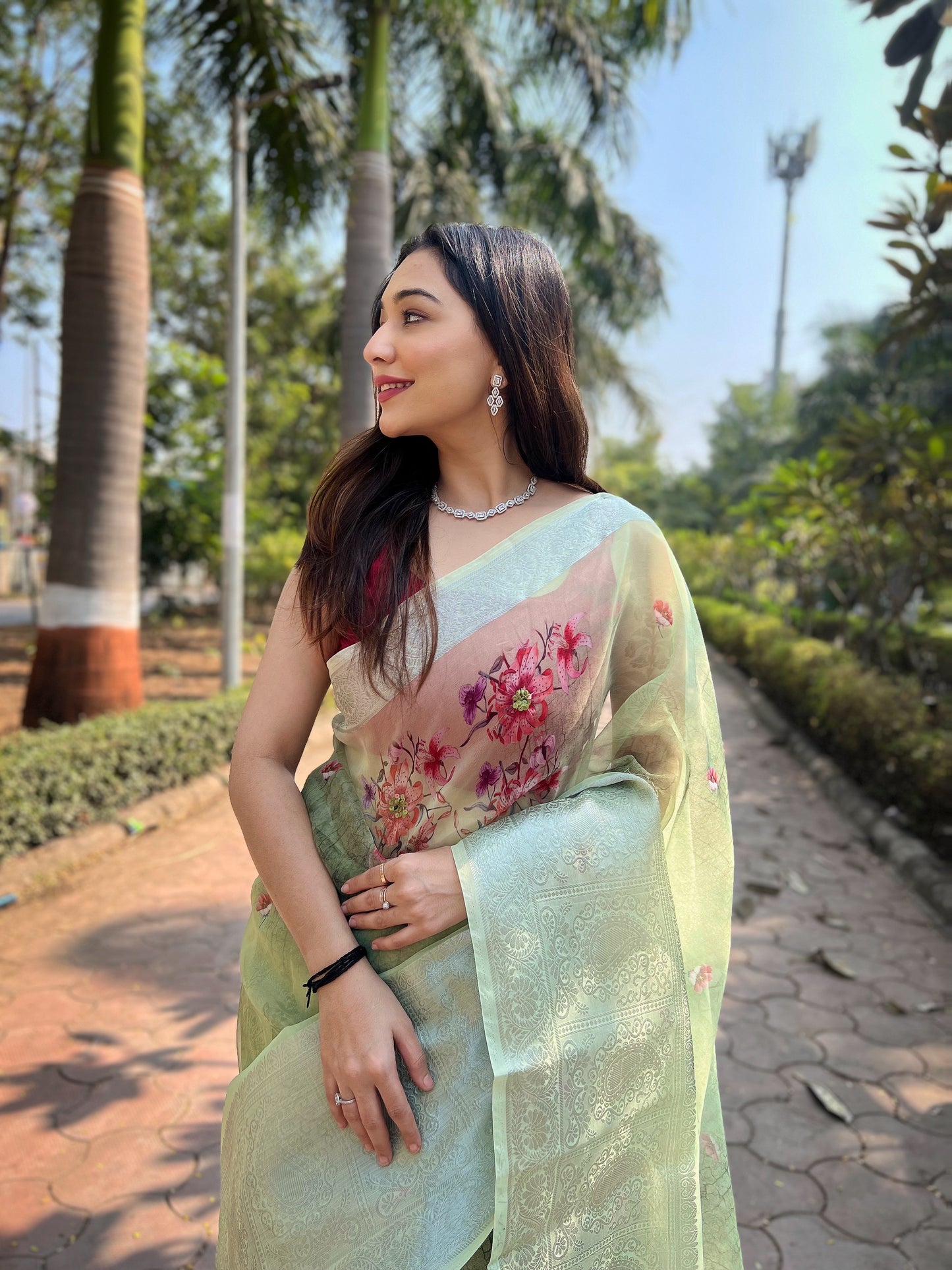 Hand-Woven Pista-Green Pure Organza Silk Saree featuring a Pure Zari Border, Hand-Painted Designs above the Border, and Delicate Pearl Tassels with Blouse
