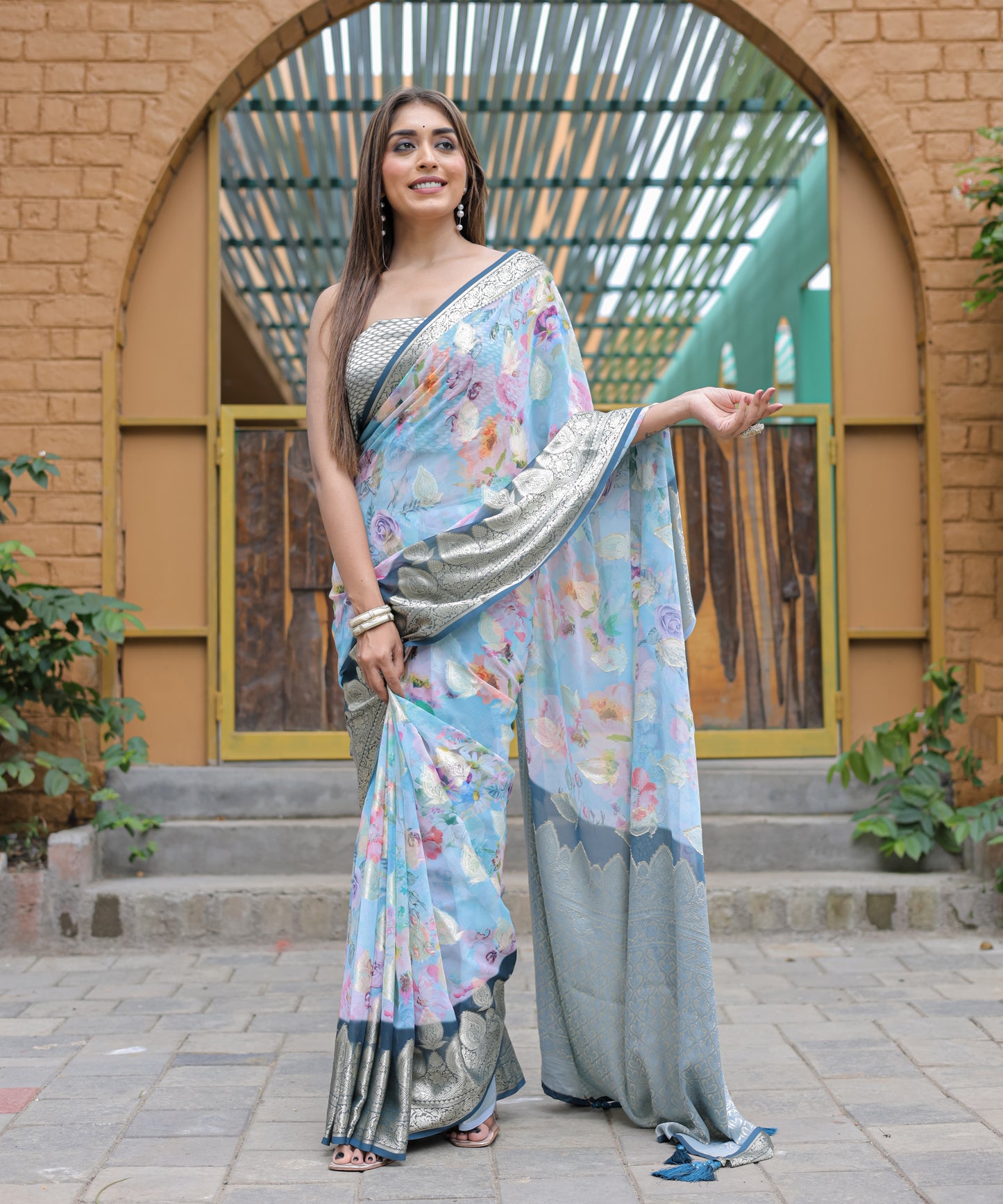 Pure Georgette Powder-Blue saree in Digital-Print with Dark-Blue Heavy Zari Border and Tassels paired with Blouse