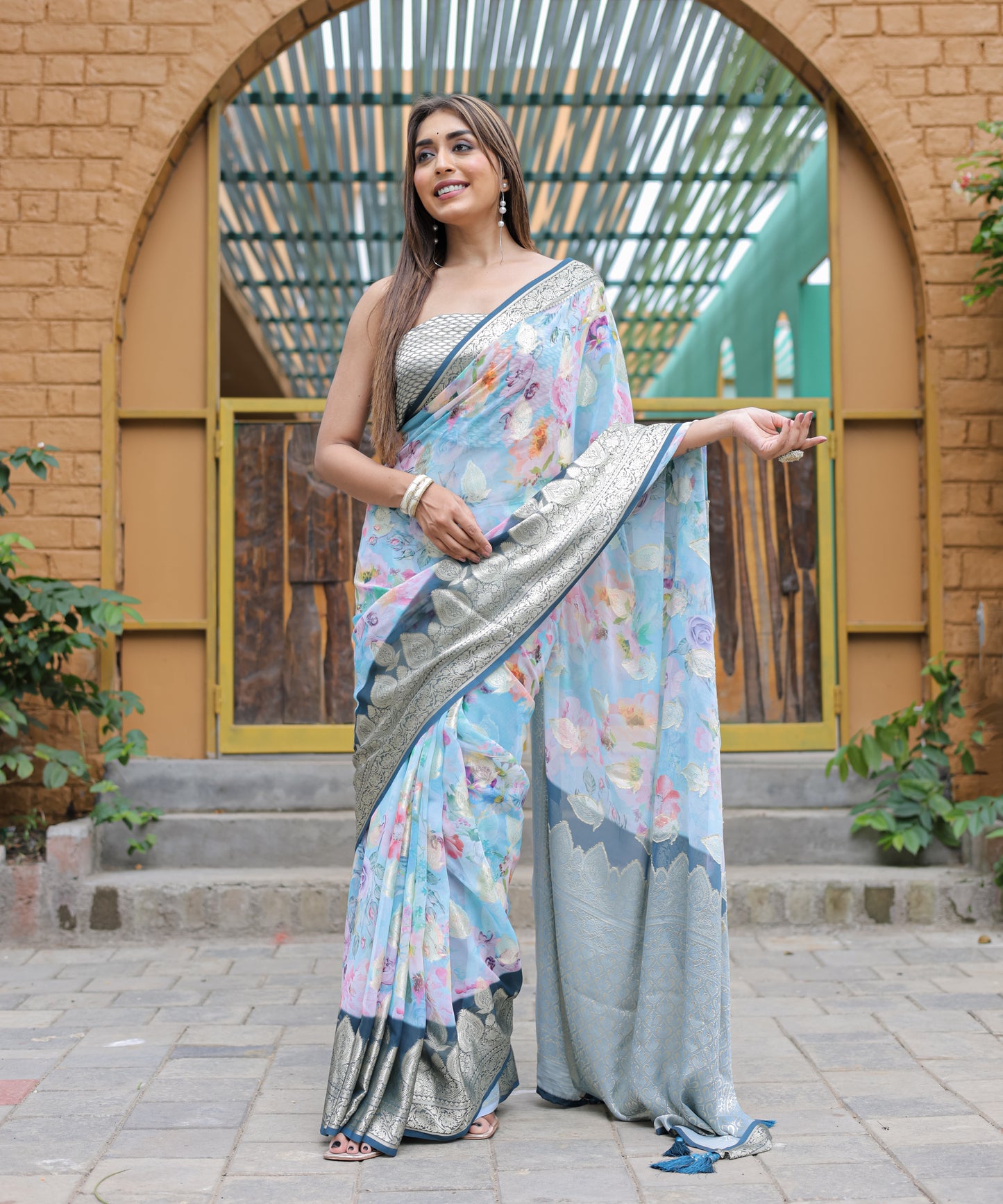 Pure Georgette Powder-Blue saree in Digital-Print with Dark-Blue Heavy Zari Border and Tassels paired with Blouse