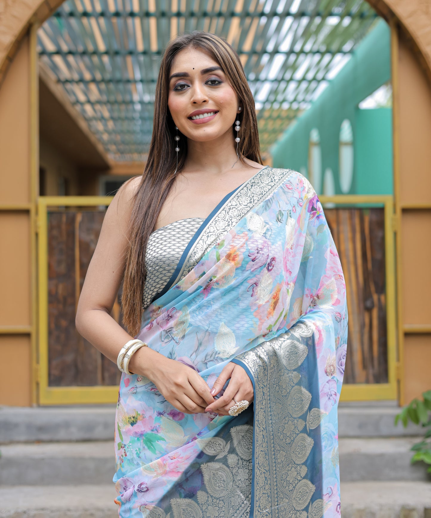 Pure Georgette Powder-Blue saree in Digital-Print with Dark-Blue Heavy Zari Border and Tassels paired with Blouse