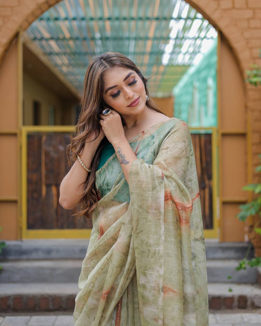 Mehendi-Green Pure Organza-Silk saree with all over Zari Sequins and Tassels paired with Blouse