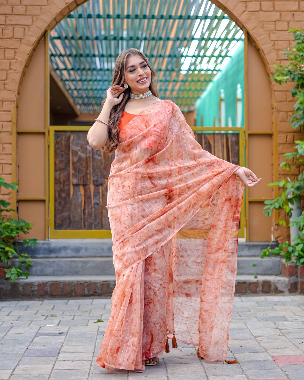 Soft-Orange Pure Organza-Silk saree with all over Zari Sequins and Tassels paired with Blouse