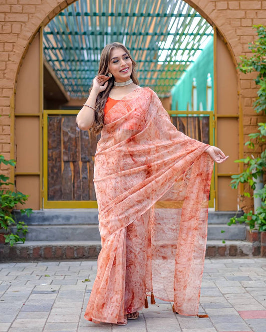 Soft-Orange Pure Organza-Silk saree with all over Zari Sequins and Tassels paired with Blouse