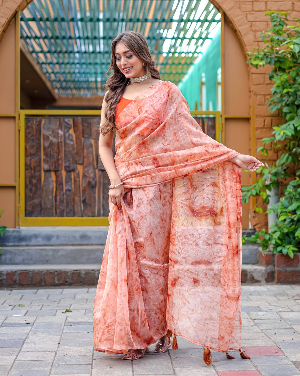 Soft-Orange Pure Organza-Silk saree with all over Zari Sequins and Tassels paired with Blouse