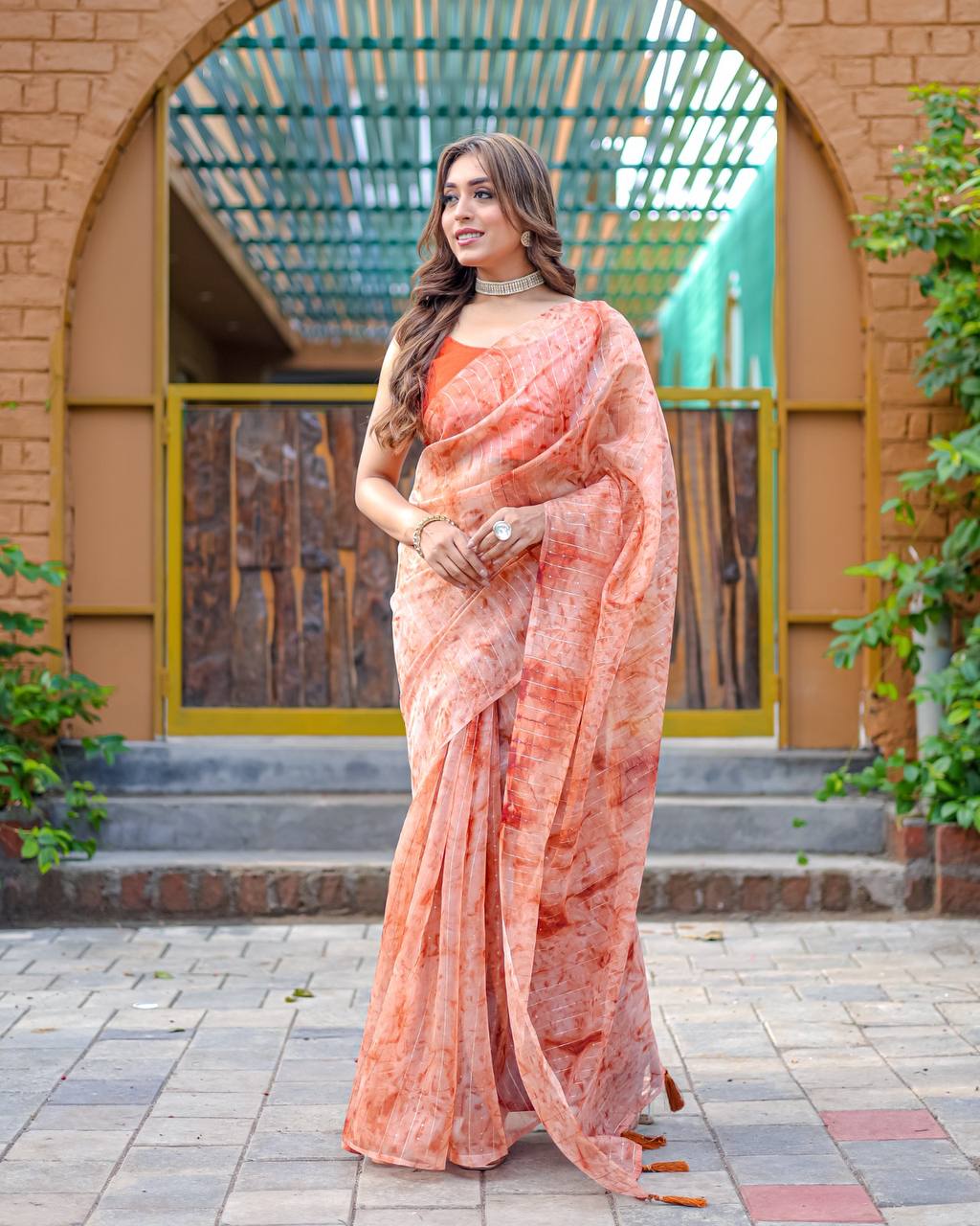 Soft-Orange Pure Organza-Silk saree with all over Zari Sequins and Tassels paired with Blouse