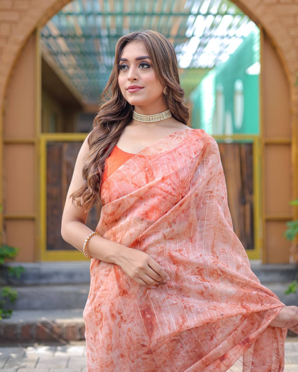 Soft-Orange Pure Organza-Silk saree with all over Zari Sequins and Tassels paired with Blouse