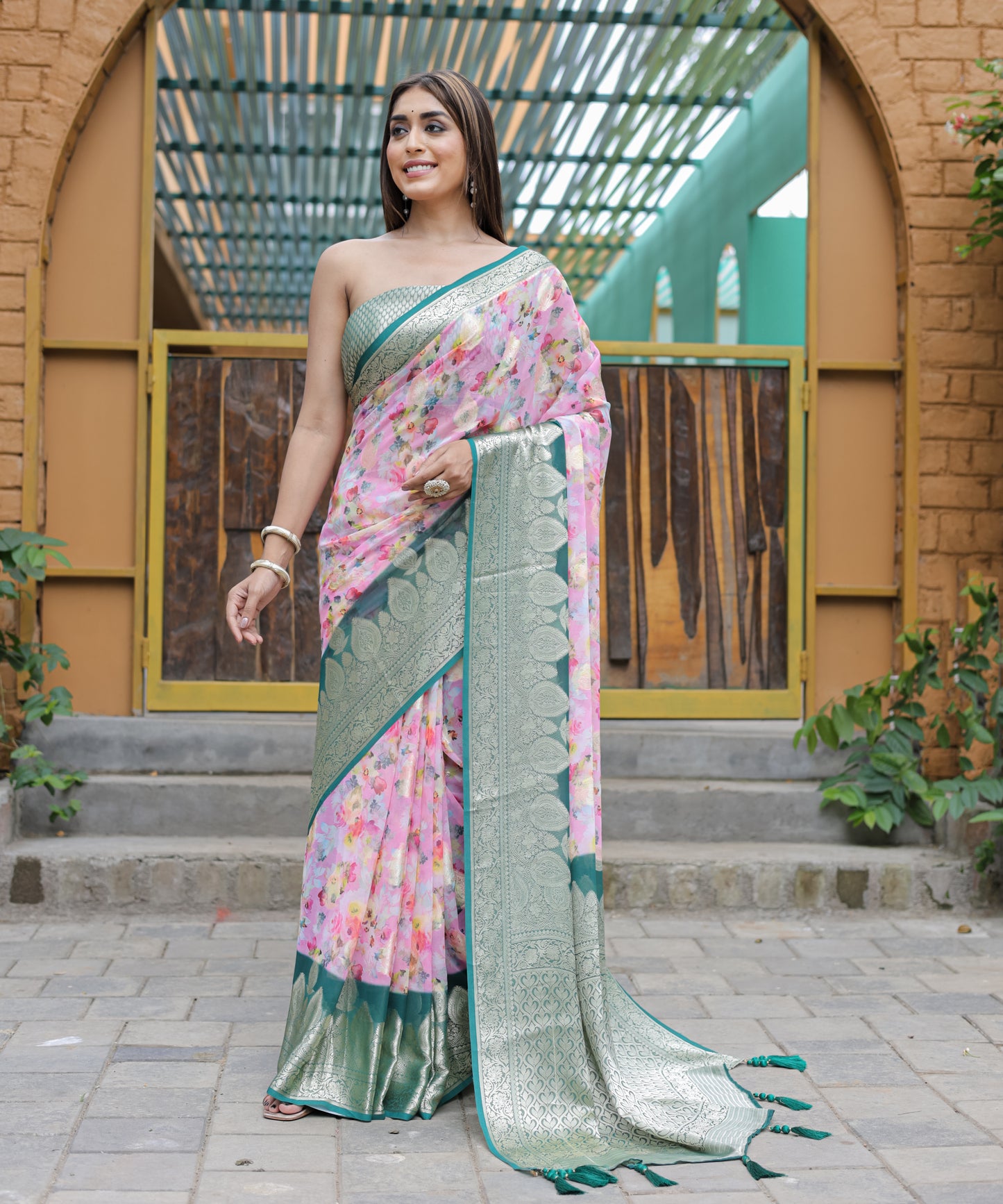 Pure Georgette Light-Pink saree in Digital-Print with Teal Heavy Zari Border and Tassels paired with Blouse