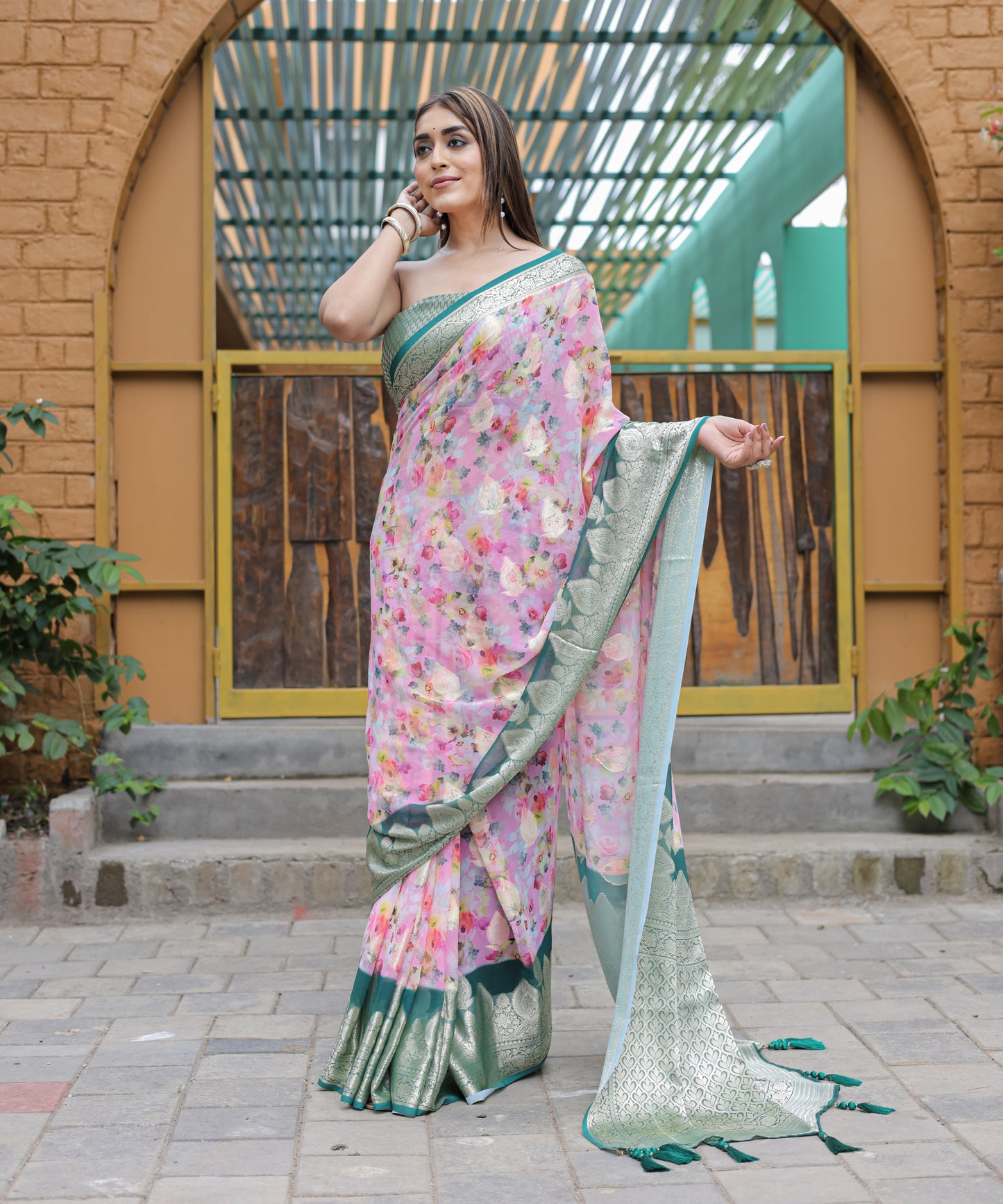 Pure Georgette Light-Pink saree in Digital-Print with Teal Heavy Zari Border and Tassels paired with Blouse
