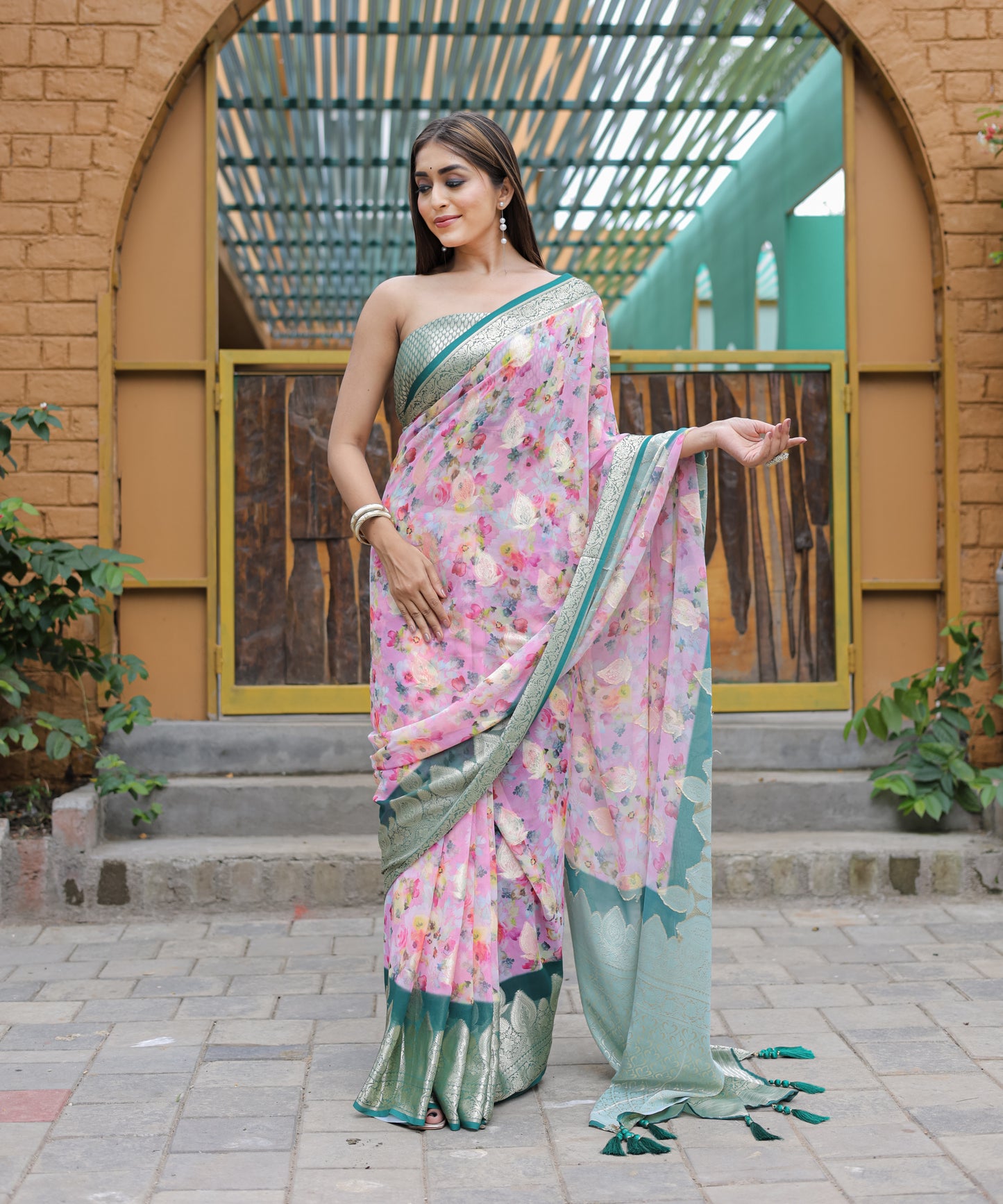Pure Georgette Light-Pink saree in Digital-Print with Teal Heavy Zari Border and Tassels paired with Blouse