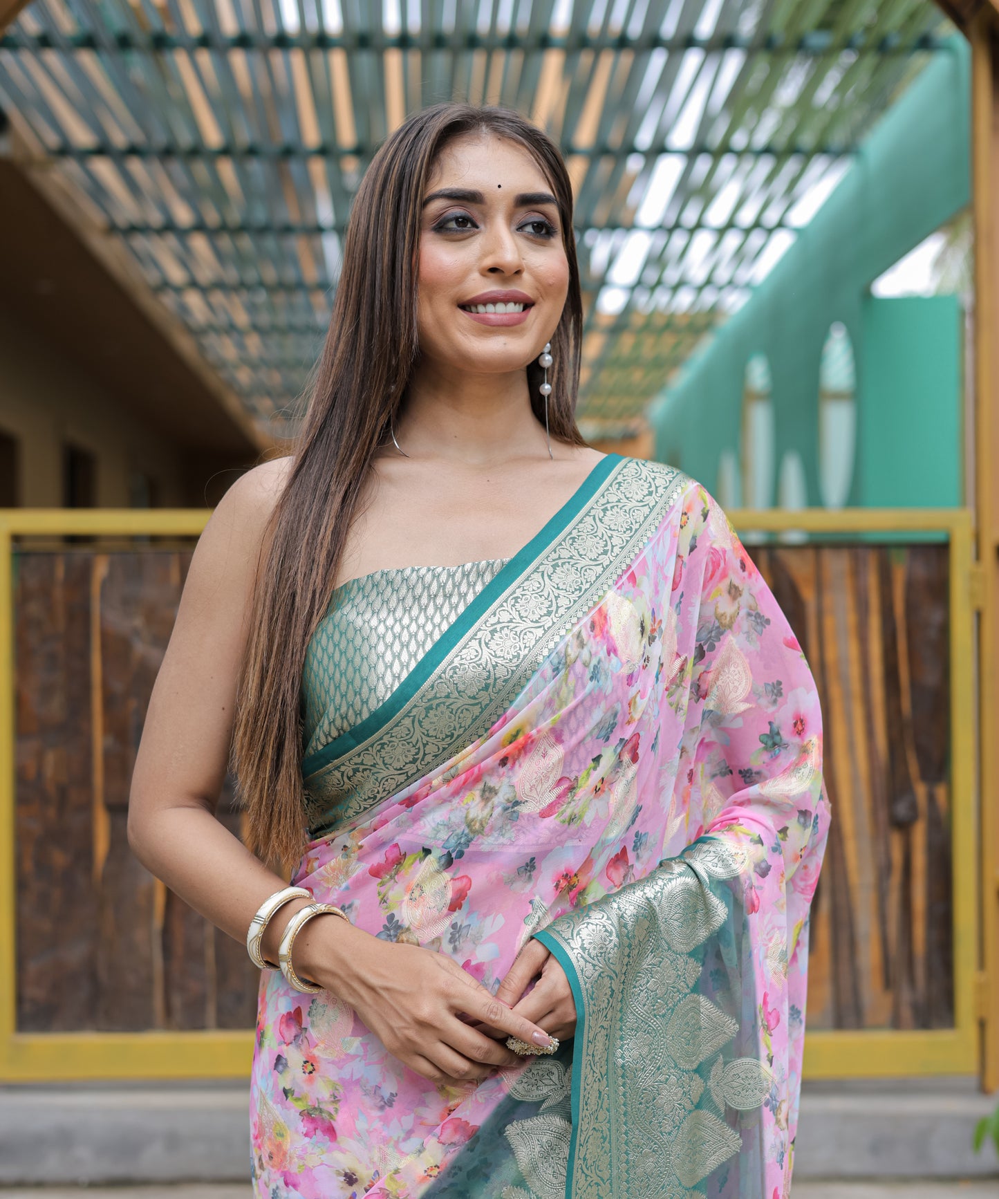 Pure Georgette Light-Pink saree in Digital-Print with Teal Heavy Zari Border and Tassels paired with Blouse