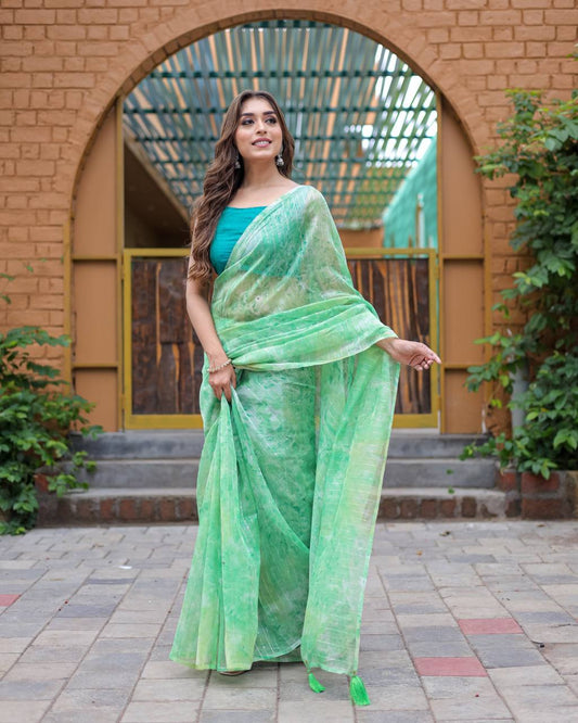 Pista-Green Pure Organza-Silk saree with all over Zari Sequins and Tassels paired with Blouse