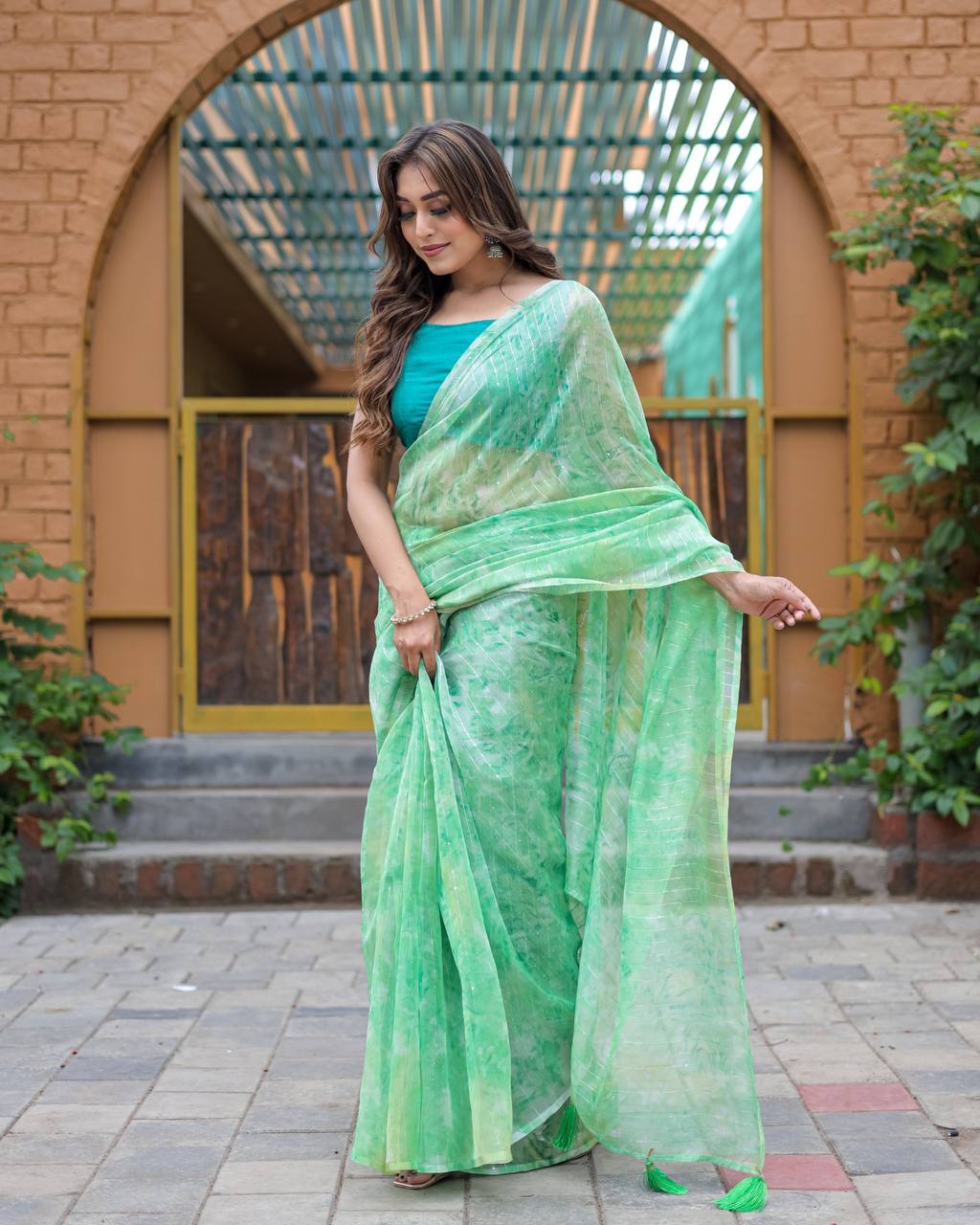 Pista-Green Pure Organza-Silk saree with all over Zari Sequins and Tassels paired with Blouse