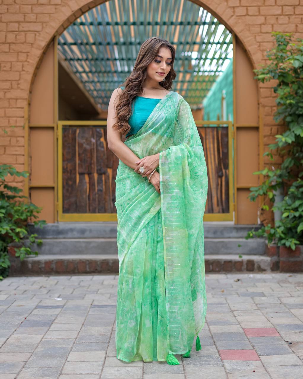 Pista-Green Pure Organza-Silk saree with all over Zari Sequins and Tassels paired with Blouse