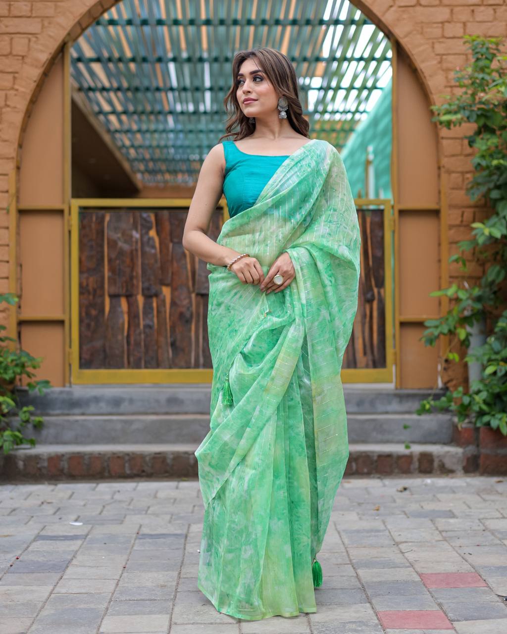 Pista-Green Pure Organza-Silk saree with all over Zari Sequins and Tassels paired with Blouse