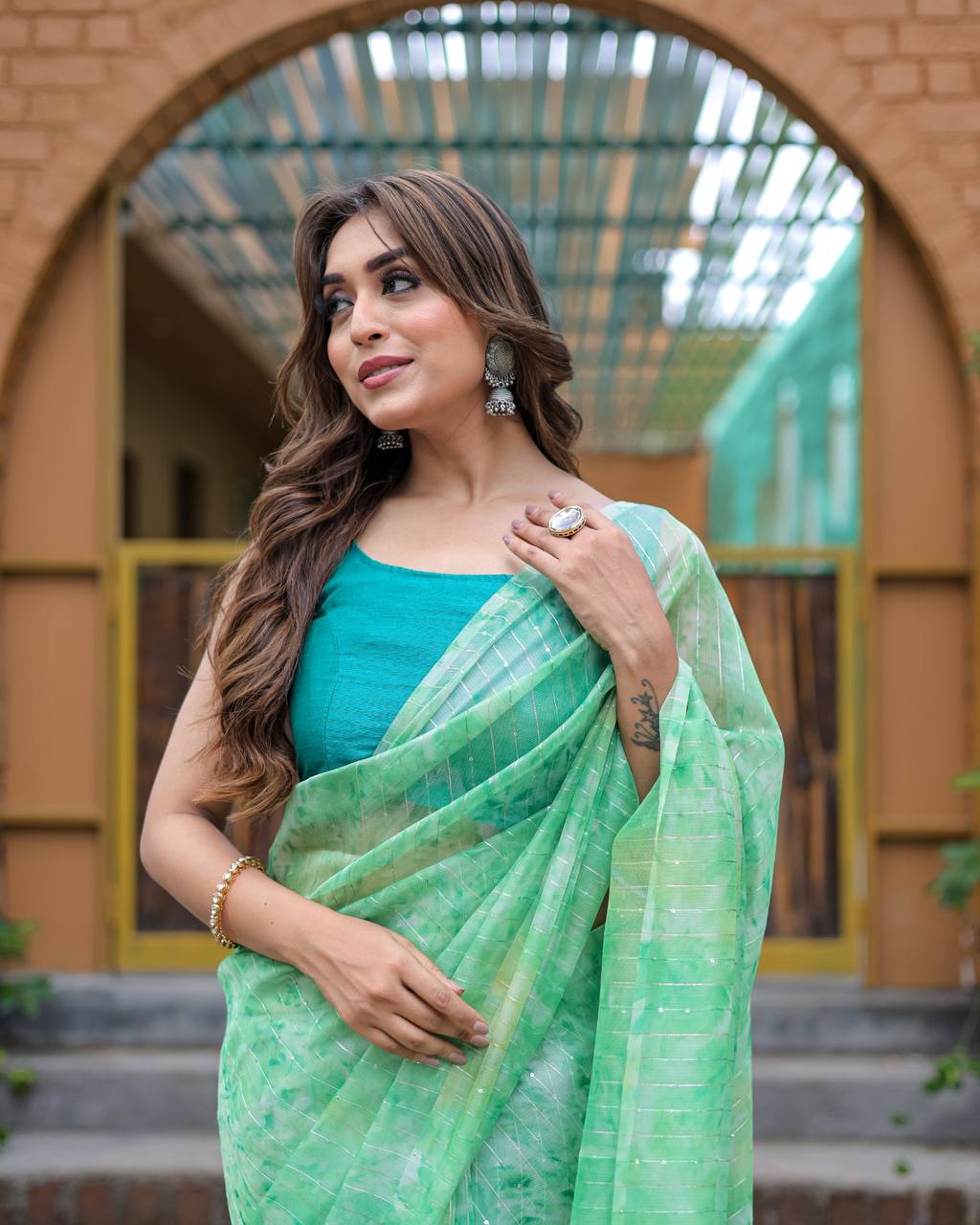 Pista-Green Pure Organza-Silk saree with all over Zari Sequins and Tassels paired with Blouse