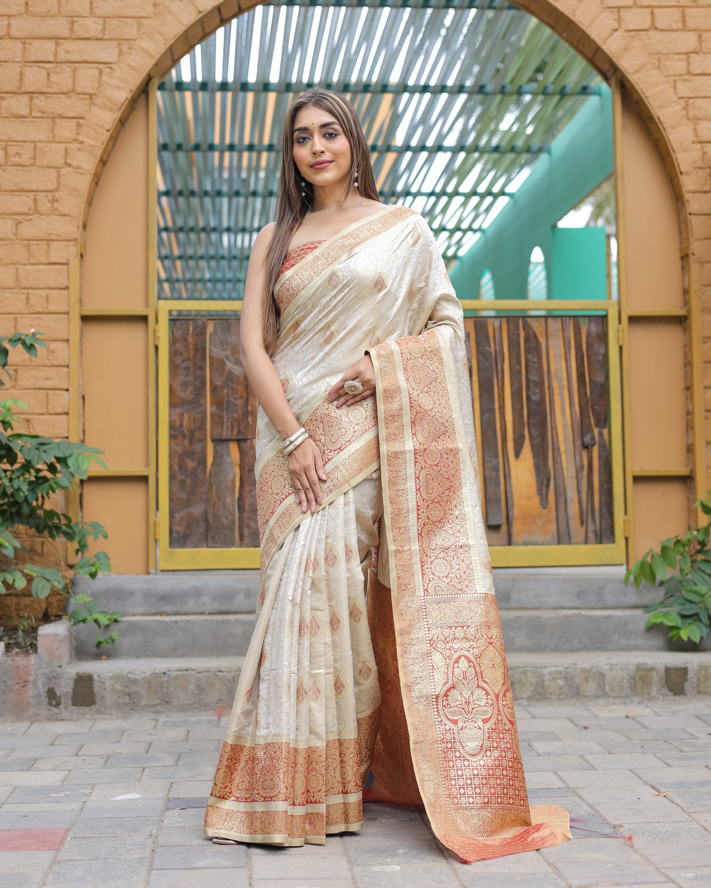 Heavy Embroidered Off-White saree with Red Zari Border paired with Blouse