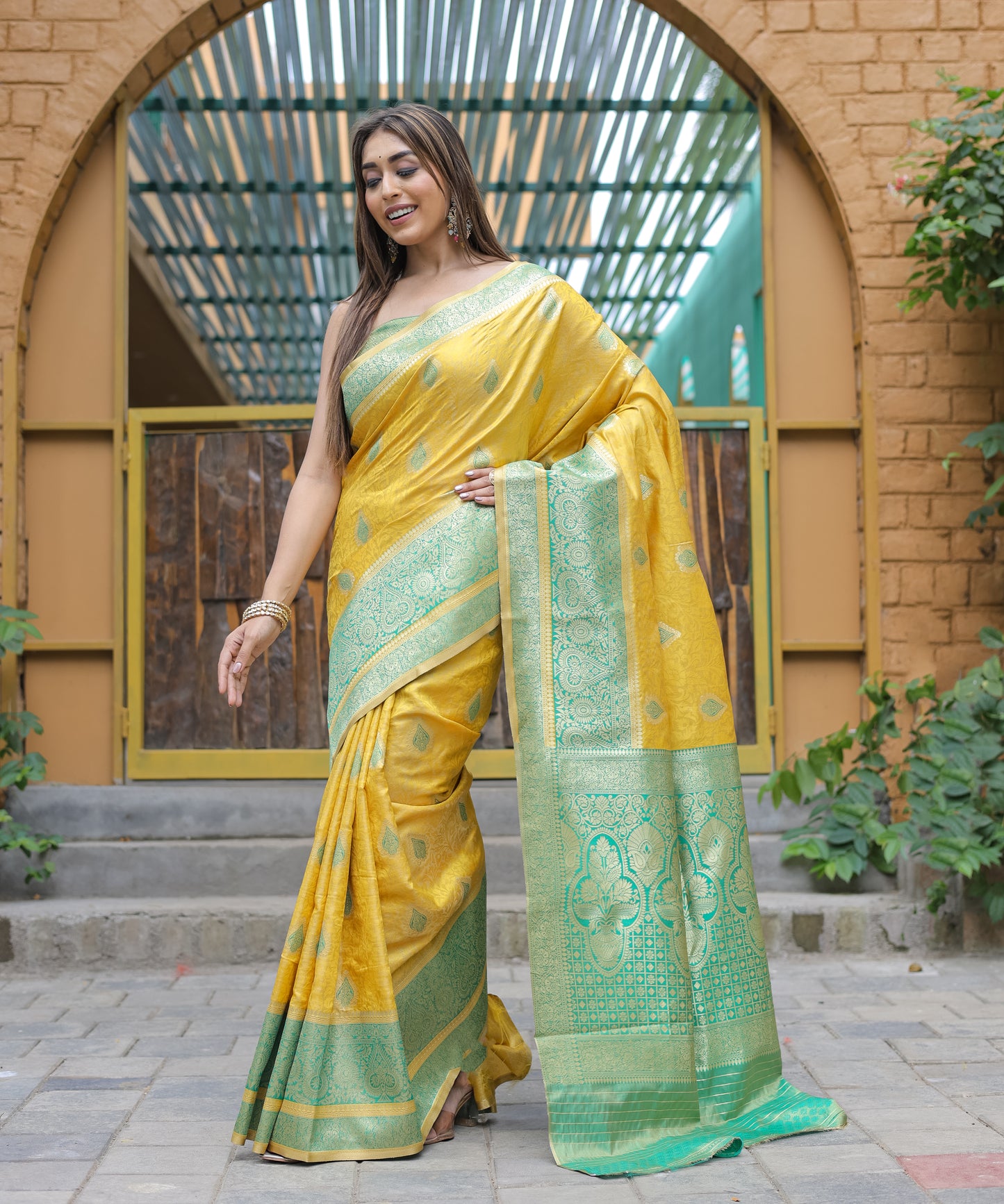 Heavy Embroidered Bright-Yellow saree with Sea-Green Zari Border paired with Blouse