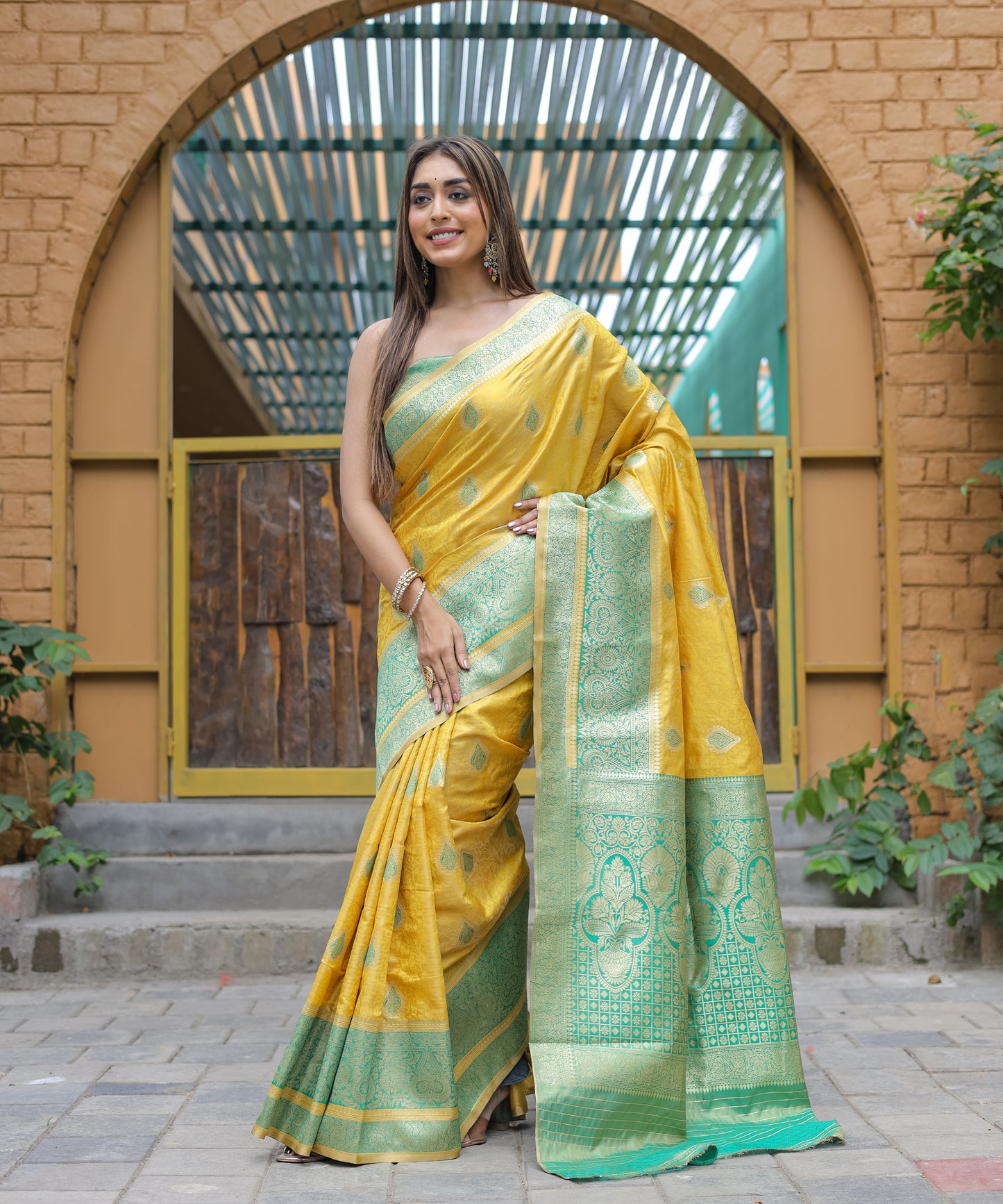 Heavy Embroidered Bright-Yellow saree with Sea-Green Zari Border paired with Blouse