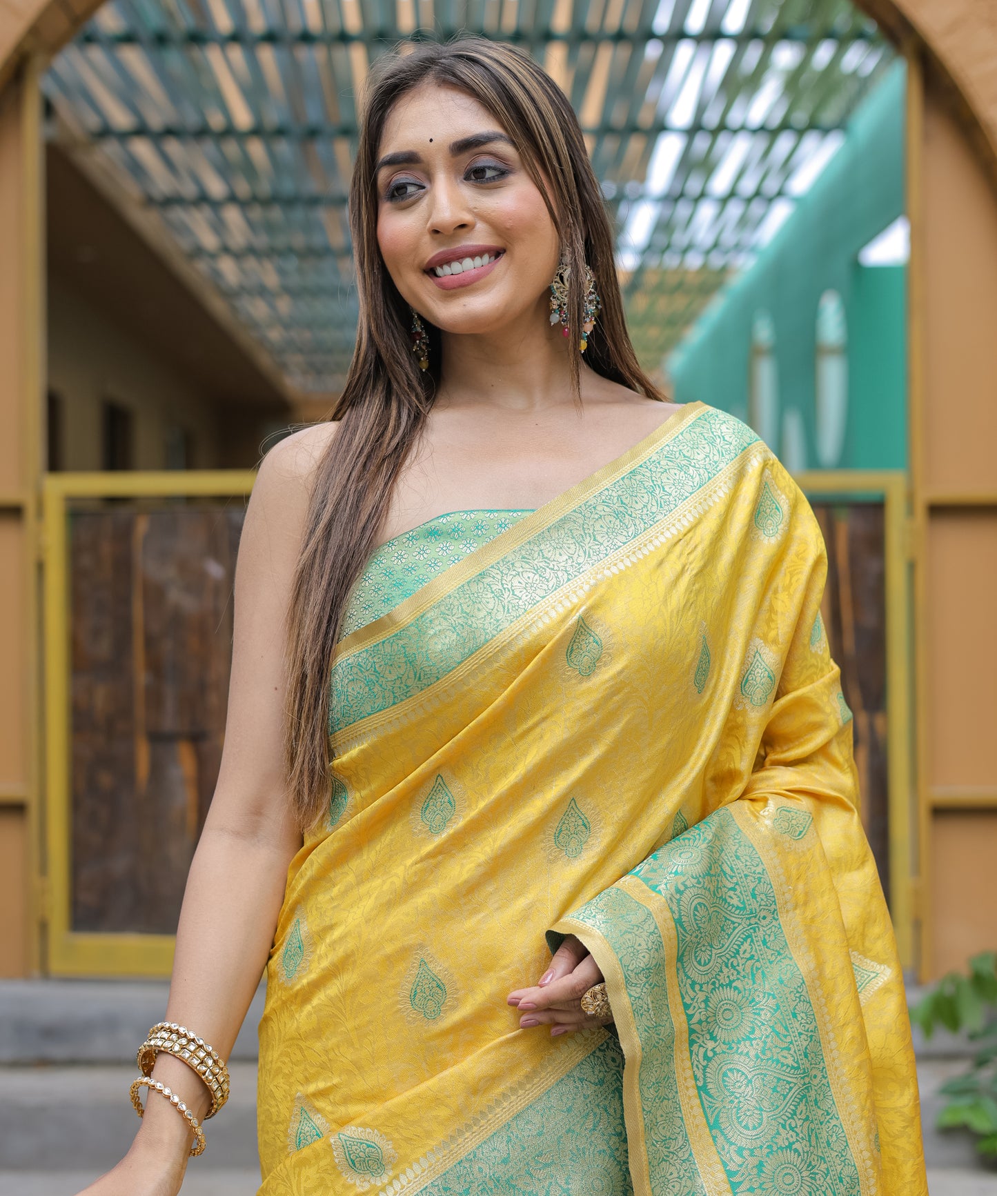 Heavy Embroidered Bright-Yellow saree with Sea-Green Zari Border paired with Blouse